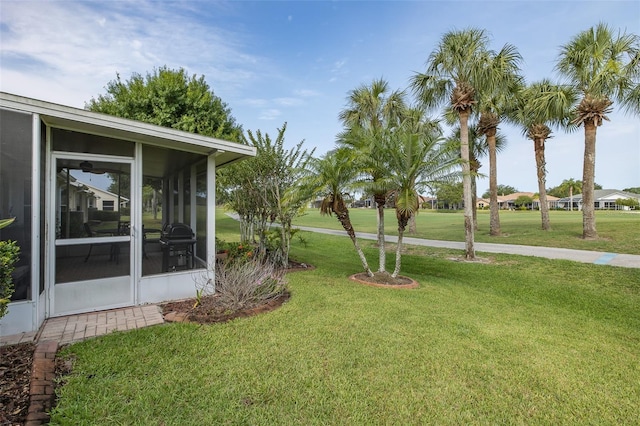 1105 Flora Vista St, New Port Richey, FL 34655 - view of green lawn featuring a sunroom