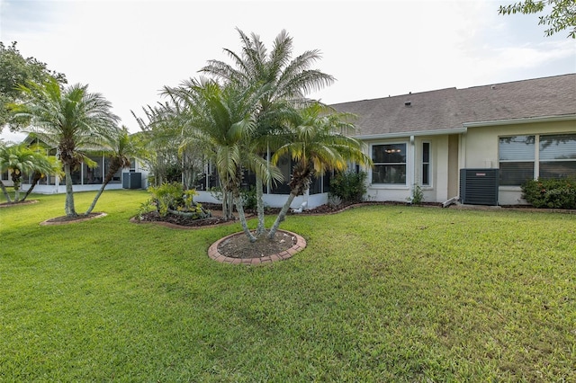 1105 Flora Vista St, New Port Richey, FL 34655 - view of green lawn featuring central AC unit