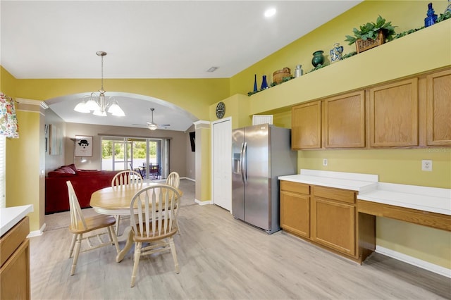 1009 Summer Breeze Dr, Brandon, FL 33511 - kitchen with stainless steel fridge, arched walkways, light wood-type flooring, and light countertops