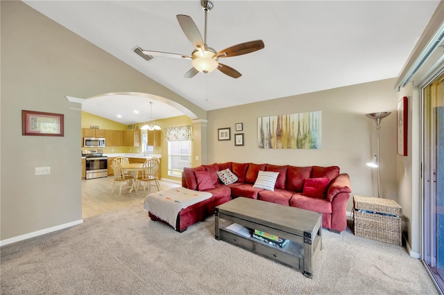 1009 Summer Breeze Dr, Brandon, FL 33511 - living area with arched walkways, vaulted ceiling, ceiling fan, light carpet, and baseboards
