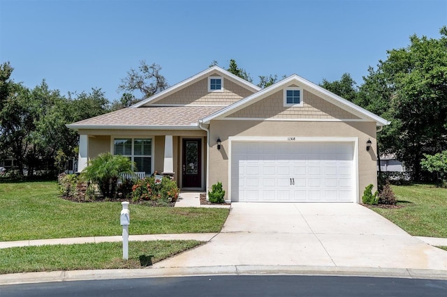 11308 Mollymawk Ct, New Port Richey, FL 34654 - craftsman house with stucco siding, a front lawn, an attached garage, and driveway