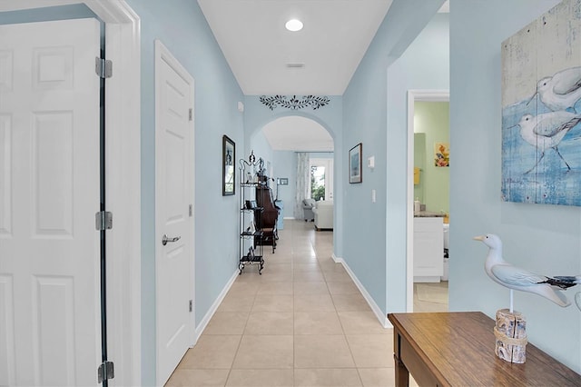 11308 Mollymawk Ct, New Port Richey, FL 34654 - hall featuring arched walkways, light tile patterned floors, and baseboards