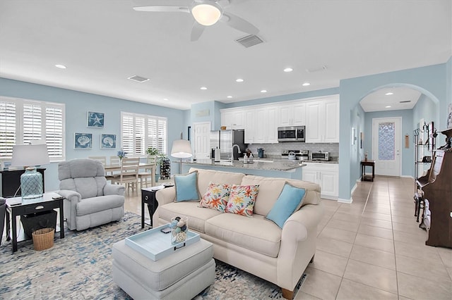 11308 Mollymawk Ct, New Port Richey, FL 34654 - living area with arched walkways, ceiling fan, light tile patterned floors, and recessed lighting