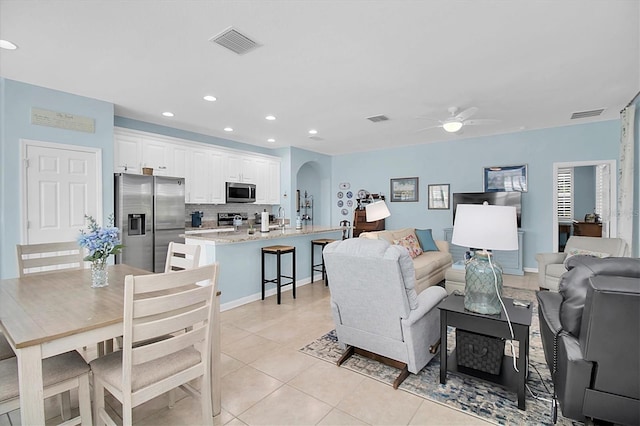 11308 Mollymawk Ct, New Port Richey, FL 34654 - living room with a ceiling fan, arched walkways, light tile patterned floors, and recessed lighting