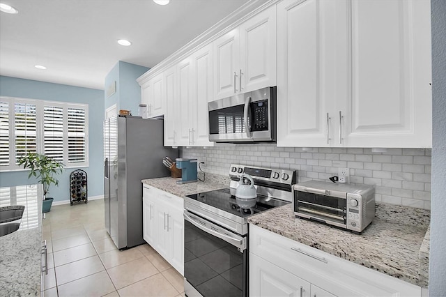 11308 Mollymawk Ct, New Port Richey, FL 34654 - kitchen with stainless steel appliances, decorative backsplash, white cabinetry, and recessed lighting