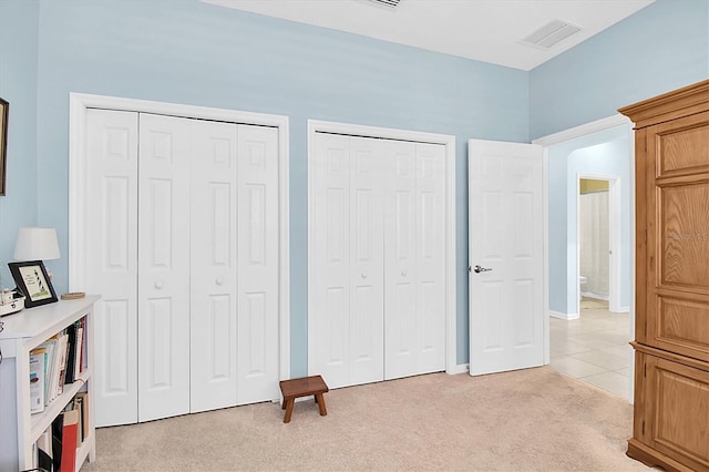 11308 Mollymawk Ct, New Port Richey, FL 34654 - unfurnished bedroom featuring multiple closets, light colored carpet, and baseboards