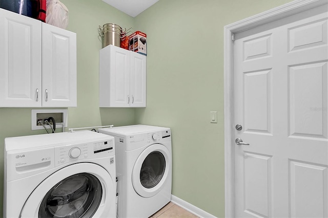 11308 Mollymawk Ct, New Port Richey, FL 34654 - washroom featuring washing machine and dryer, cabinet space, light tile patterned floors, and baseboards