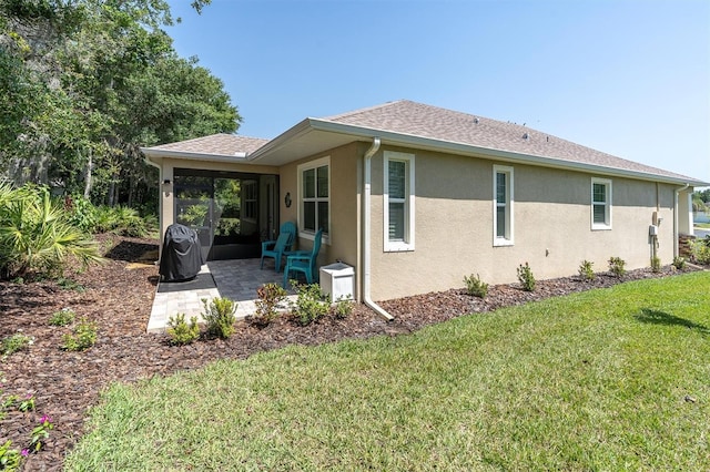 11308 Mollymawk Ct, New Port Richey, FL 34654 - view of side of home featuring a patio area, stucco siding, and a yard