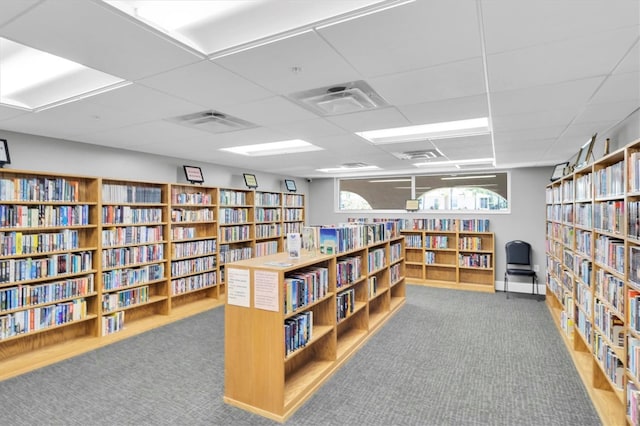 11308 Mollymawk Ct, New Port Richey, FL 34654 - misc room with wall of books, carpet, and a drop ceiling