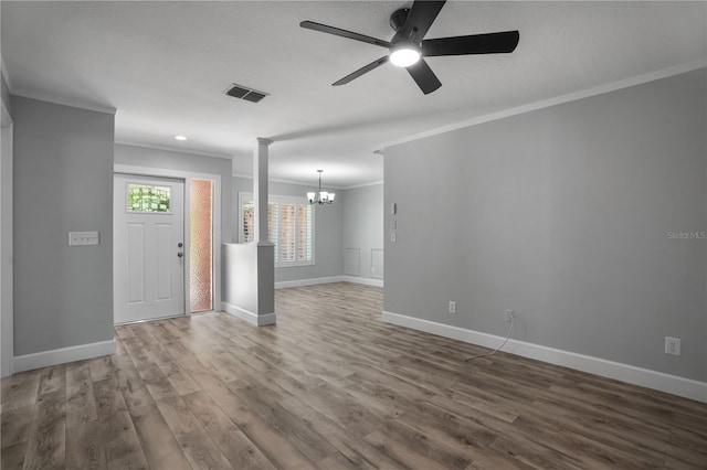 2866 Thistle Ct N, Palm Harbor, FL 34684 - unfurnished living room featuring a chandelier, ornamental molding, wood finished floors, baseboards, and ceiling fan