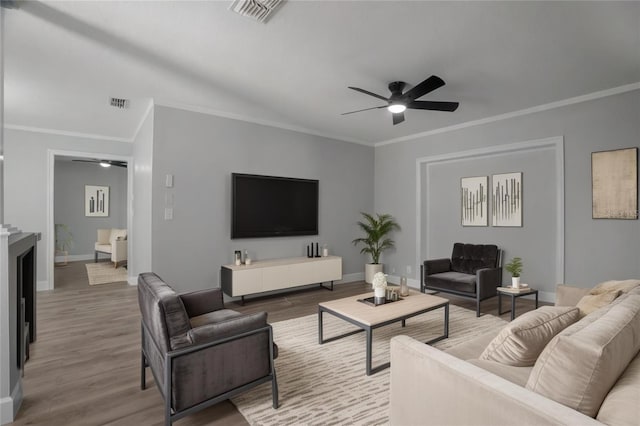 2866 Thistle Ct N, Palm Harbor, FL 34684 - living room with ceiling fan, wood finished floors, baseboards, and ornamental molding