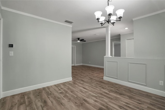 2866 Thistle Ct N, Palm Harbor, FL 34684 - spare room with crown molding, a ceiling fan, baseboards, a chandelier, and wood finished floors