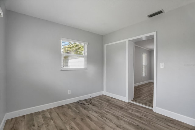 2866 Thistle Ct N, Palm Harbor, FL 34684 - unfurnished bedroom with baseboards and wood finished floors