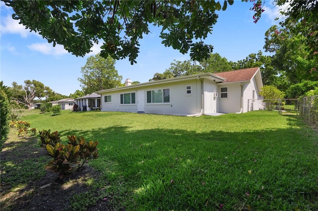2866 Thistle Ct N, Palm Harbor, FL 34684 - back of property with stucco siding and a chimney