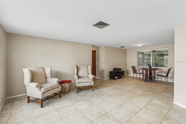 4424 Whitetail Ln, New Port Richey, FL 34653 - living area featuring a textured ceiling, baseboards, and light tile patterned floors