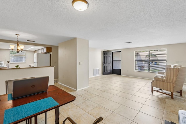 4424 Whitetail Ln, New Port Richey, FL 34653 - living area with a chandelier, a textured ceiling, light tile patterned floors, and baseboards