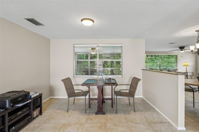 4424 Whitetail Ln, New Port Richey, FL 34653 - dining area featuring light tile patterned flooring, baseboards, a textured ceiling, and a ceiling fan