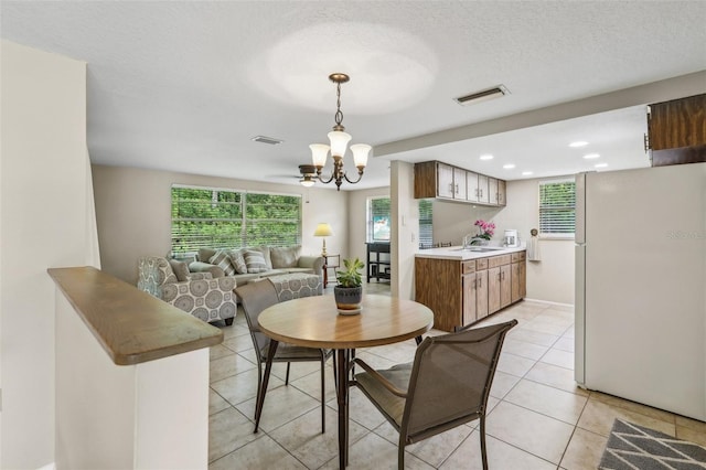 4424 Whitetail Ln, New Port Richey, FL 34653 - dining area with a chandelier, light tile patterned floors, recessed lighting, baseboards, and a textured ceiling