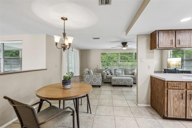 4424 Whitetail Ln, New Port Richey, FL 34653 - dining space with a ceiling fan, light tile patterned floors, baseboards, and a chandelier