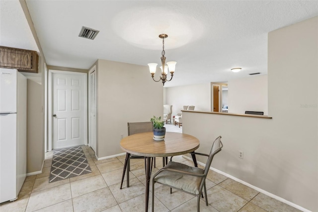 4424 Whitetail Ln, New Port Richey, FL 34653 - dining room with baseboards, light tile patterned floors, and a chandelier