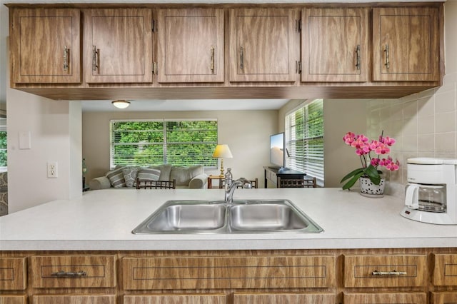 4424 Whitetail Ln, New Port Richey, FL 34653 - kitchen with a sink, light countertops, and brown cabinetry