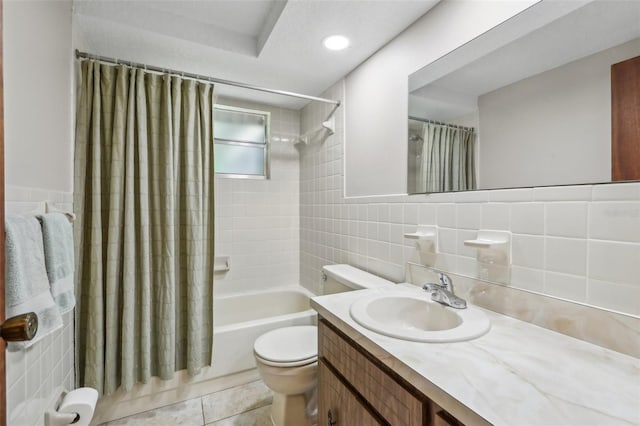 4424 Whitetail Ln, New Port Richey, FL 34653 - full bathroom featuring toilet, shower / bath combo with shower curtain, vanity, tile walls, and tile patterned floors