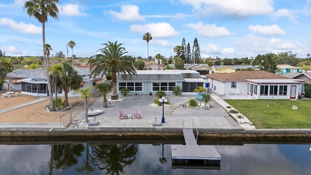 3907 Headsail Dr, New Port Richey, FL 34652 - back of house with a sunroom, a water view, and a patio