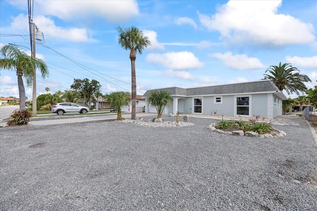 3907 Headsail Dr, New Port Richey, FL 34652 - single story home featuring driveway, roof with shingles, and stucco siding
