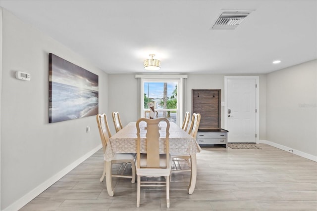 3907 Headsail Dr, New Port Richey, FL 34652 - dining room with light wood-style flooring and recessed lighting