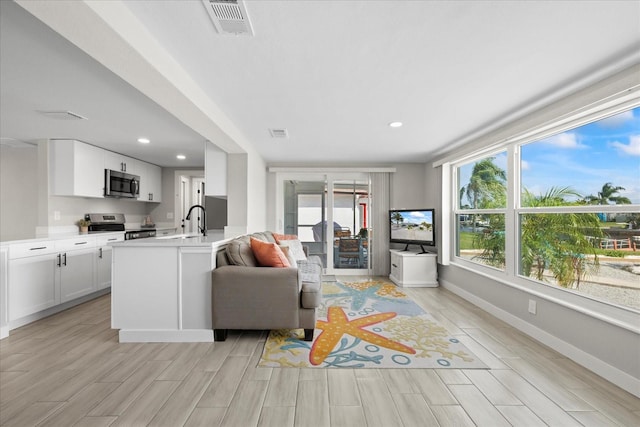 3907 Headsail Dr, New Port Richey, FL 34652 - living room featuring wood finish floors and recessed lighting