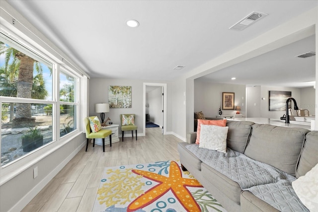 3907 Headsail Dr, New Port Richey, FL 34652 - living area with light wood-style flooring and recessed lighting