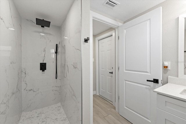 3907 Headsail Dr, New Port Richey, FL 34652 - full bath with vanity, a marble finish shower, and wood finished floors
