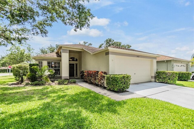 1407 Hickory Moss Pl, Trinity, FL 34655 - ranch-style home with an attached garage, stucco siding, a front lawn, and driveway
