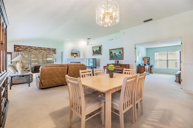 1407 Hickory Moss Pl, Trinity, FL 34655 - dining space featuring light colored carpet, a chandelier, a tile fireplace, and lofted ceiling