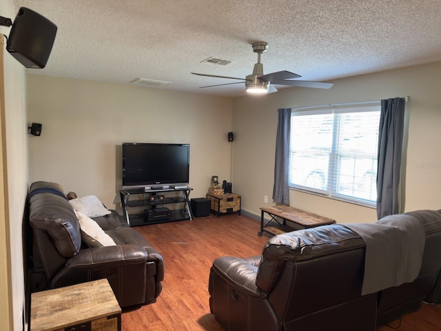 13180 Lawrence St, Spring Hill, FL 34609 - living area with a ceiling fan, wood finished floors, and a textured ceiling