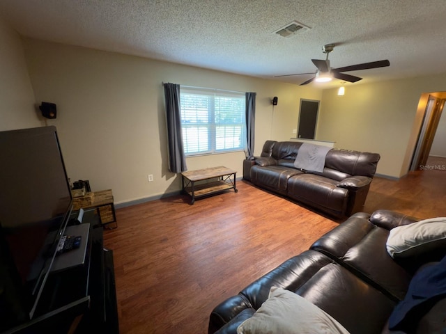 13180 Lawrence St, Spring Hill, FL 34609 - living area with wood finished floors, a ceiling fan, a textured ceiling, and baseboards