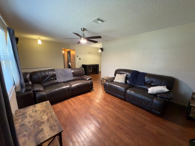 13180 Lawrence St, Spring Hill, FL 34609 - living room with a ceiling fan, wood finished floors, and a textured ceiling