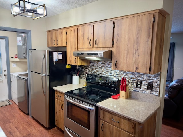 13180 Lawrence St, Spring Hill, FL 34609 - kitchen featuring appliances with stainless steel finishes, under cabinet range hood, wood finished floors, backsplash, and a textured ceiling