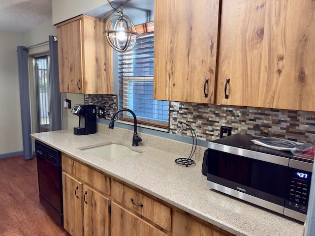 13180 Lawrence St, Spring Hill, FL 34609 - kitchen with stainless steel microwave, a sink, black dishwasher, tasteful backsplash, and a textured ceiling