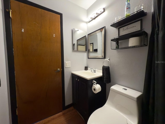 13180 Lawrence St, Spring Hill, FL 34609 - bathroom featuring toilet, wood finished floors, and vanity