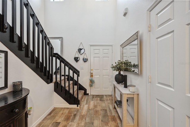 1108 Blackwater Dr, Wesley Chapel, FL 33543 - foyer entrance with light wood-type flooring, stairs, a high ceiling, and baseboards