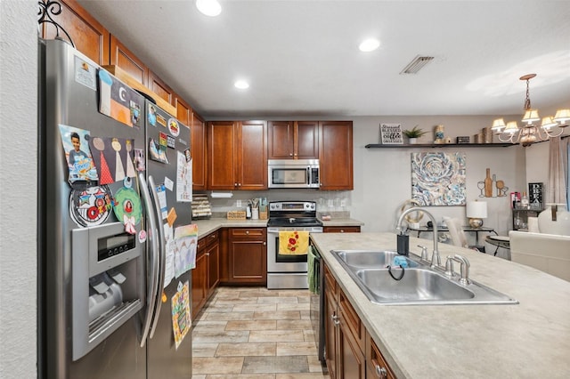 1108 Blackwater Dr, Wesley Chapel, FL 33543 - kitchen featuring stainless steel appliances, a sink, light countertops, a chandelier, and recessed lighting