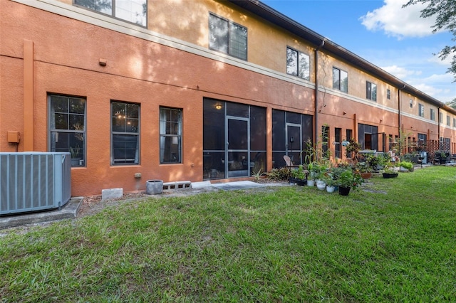 1108 Blackwater Dr, Wesley Chapel, FL 33543 - back of house with central air condition unit, a lawn, and stucco siding