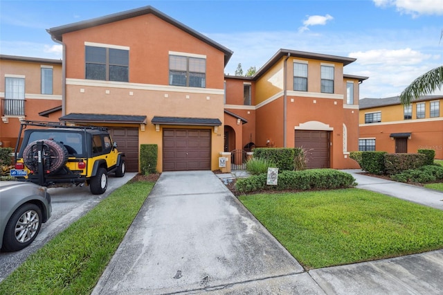 1108 Blackwater Dr, Wesley Chapel, FL 33543 - townhome / multi-family property featuring a garage, driveway, stucco siding, and a front yard