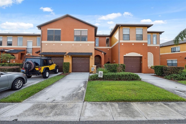 1108 Blackwater Dr, Wesley Chapel, FL 33543 - townhome / multi-family property with an attached garage, driveway, stucco siding, and a front yard