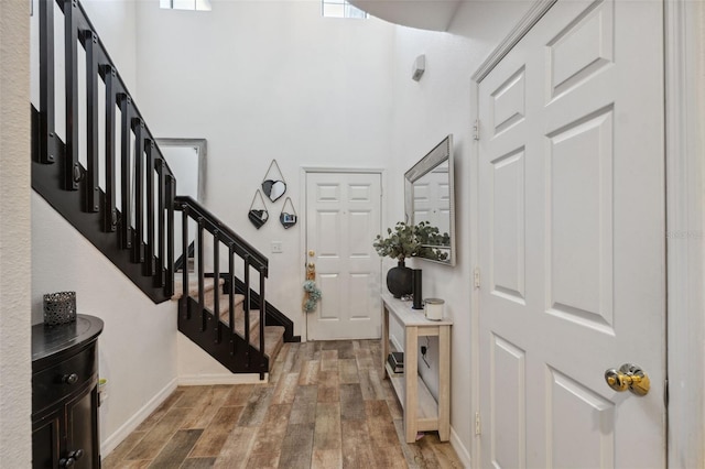 1108 Blackwater Dr, Wesley Chapel, FL 33543 - entrance foyer featuring wood finished floors, stairway, a towering ceiling, and baseboards