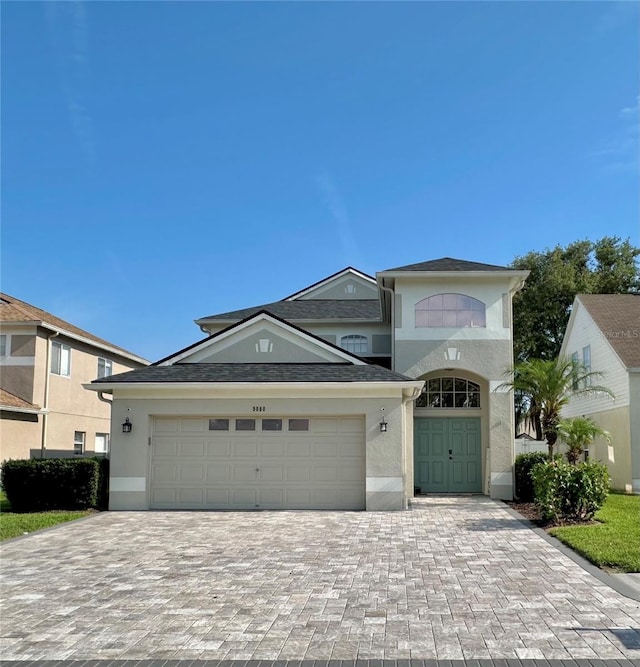 9808 Riverchase Dr, New Port Richey, FL 34655 - traditional home featuring stucco siding, decorative driveway, and a garage