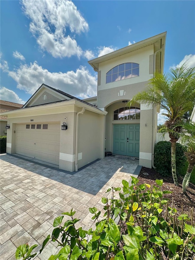9808 Riverchase Dr, New Port Richey, FL 34655 - view of front facade with stucco siding, an attached garage, and driveway