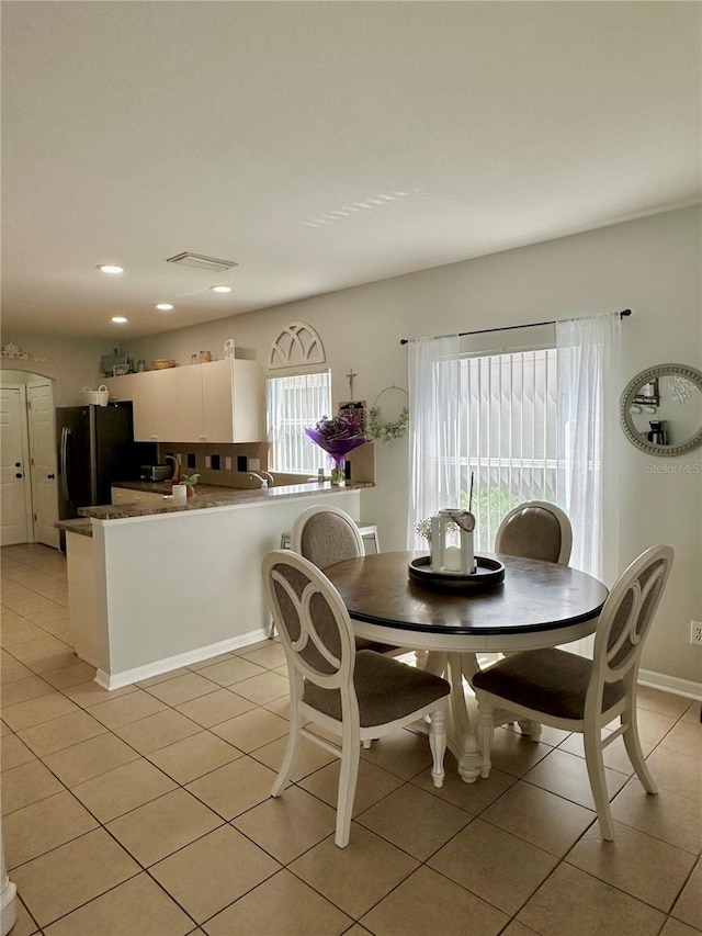 9808 Riverchase Dr, New Port Richey, FL 34655 - dining area with light tile patterned floors, recessed lighting, and baseboards