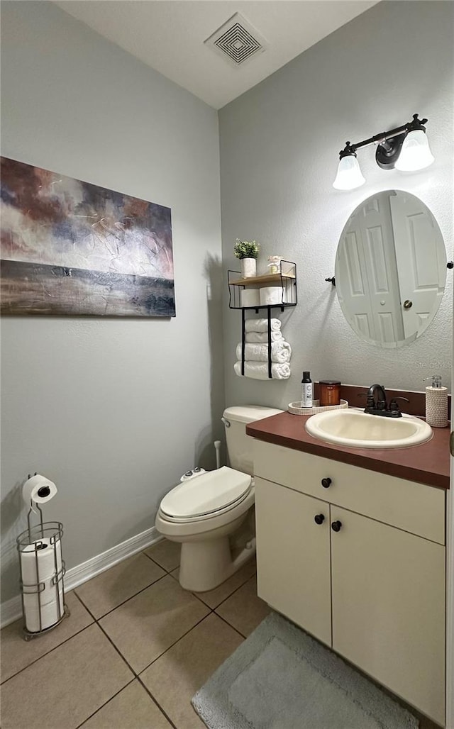 9808 Riverchase Dr, New Port Richey, FL 34655 - bathroom with tile patterned floors, toilet, vanity, and baseboards